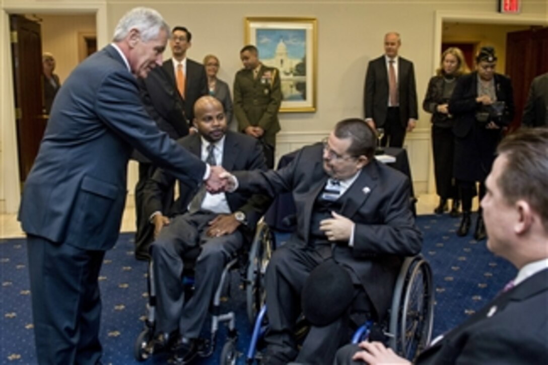 Defense Secretary Chuck Hagel greets members of the Veterans Service Organizations at the Veterans of Foreign Wars building in Washington, D.C., Jan. 27, 2015. The group honored Hagel for his efforts and Hagel thanked the group for everything they do for service members.
