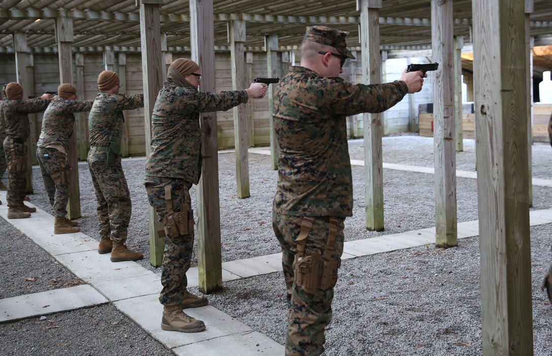 U.S. Marines with the 22nd Marine Expeditionary Unit participate in a pistol range at Marine Corps Base Camp Lejeune, N.C., Jan. 28, 2015. The unit conducted the pistol range to maintain unit readiness. (U.S. Marine Corps photo by Cpl. Caleb McDonald/Released)