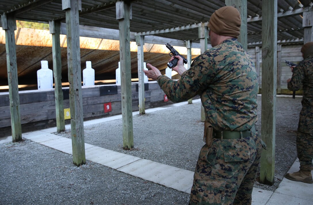 U.S. Marine Corps Master Sgt. Jarrod Duke, 22nd Marine Expeditionary Unit intelligence chief and native of Beach Grove, Tenn., performs a speed reload during a pistol range at Marine Corps Base Camp Lejeune, N.C., Jan. 28, 2015. (U.S. Marine Corps photo by Cpl. Caleb McDonald/Released)