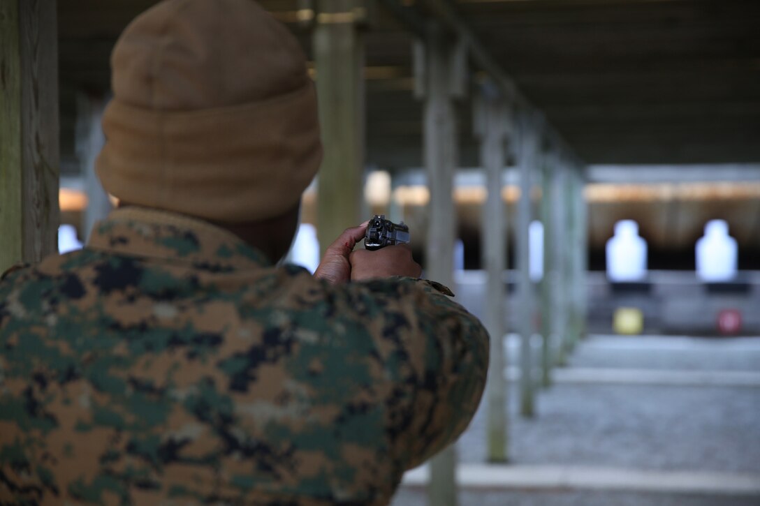 U.S. Marine Corps Cpl. Desheron Mullinswright, 22nd Marine Expeditionary Unit maintenance management chief and native of Baltimore, fires an M9 service pistol during a pistol range at Marine Corps Base Camp Lejeune, N.C., Jan. 28, 2015. (U.S. Marine Corps photo by Cpl. Caleb McDonald/Released)