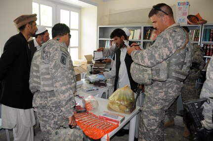 Army 1st Lt. Rodney Robinson, agri-business marketing specialist from the Texas National Guard, inventories the items that the Texas Agribusiness Development Team funded for Sanayee High School. Included were tools and seeds for the agricultural classes that 10th and 11th grade students attend.