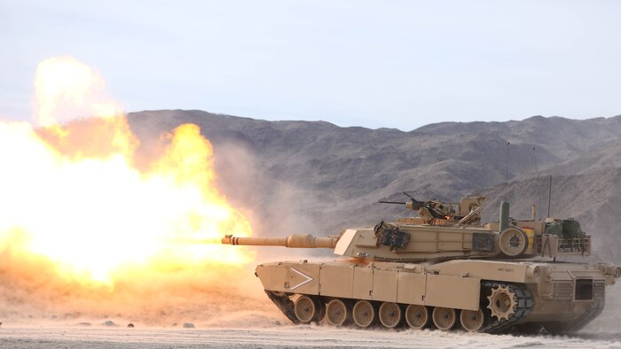 An M1A1 Abrams Tank from 1st Tank Battalion, Company B, fires its 120 mm main gun toward a target 1200 meters away during an assault on a Military Operation in Urban Terrain town on Range 210 during the Marine Corps Combat Readiness Evaluation Exercise, Jan. 20, 2015. ‘1st Tanks’ and 3rd Assault Amphibian Battalion supported 3rd Battalion, 7th Marine Regiment during their assault of the MOUT. 