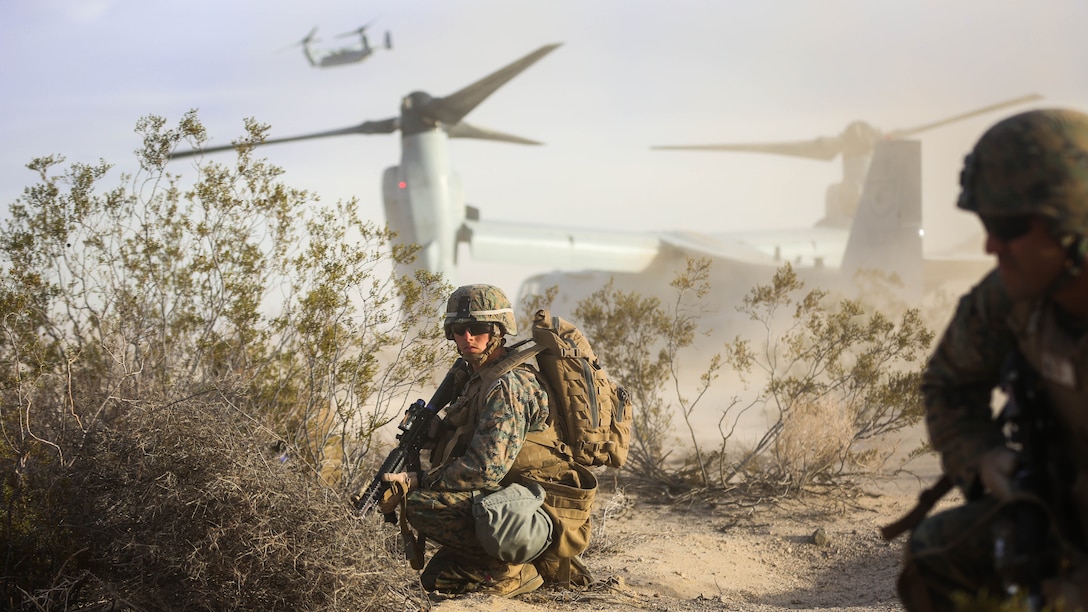 Cpl. Paul Regotti, squad leader, Company I , 3rd Battalion, 7th Marine Regiment, provides security for Marines exiting a MV-22B ‘Osprey’ tilt-rotor aircraft during an air assault on a Military Operation on Urbanized Terrain town during the Marine Corps Combat Readiness Evaluation Exercise, Jan. 16, 2015. 
