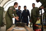 BAF BASE BANGABANDHU, Bangladesh (Jan. 27, 2015) -  U.S. Air Force Tech. Sgt. Chris Nichols (left) speaks with Bangladesh Air Force personnel from the 101st Special Flying Unit about low-cost, low-altitude airdrop bundle rigging inspection procedures during a subject matter expert exchange at Exercise Cope South.  Nichols is an instructor loadmaster assigned to the 374th Operations Support Squadron, Yokota Air Base, Japan. Cope South is a Pacific Air Forces-sponsored, bilateral tactical airlift exercise conducted in Bangladesh, with a focus on cooperative flight operations, day and night low-level navigation, tactical airdrop, and air-land missions as well as subject-matter expert exchanges in the fields of operations, maintenance and rigging disciplines. Cope South helps cultivate common bonds, foster good will, and improve readiness and compatibility between members of the Bangladesh and U.S. Air Forces. 