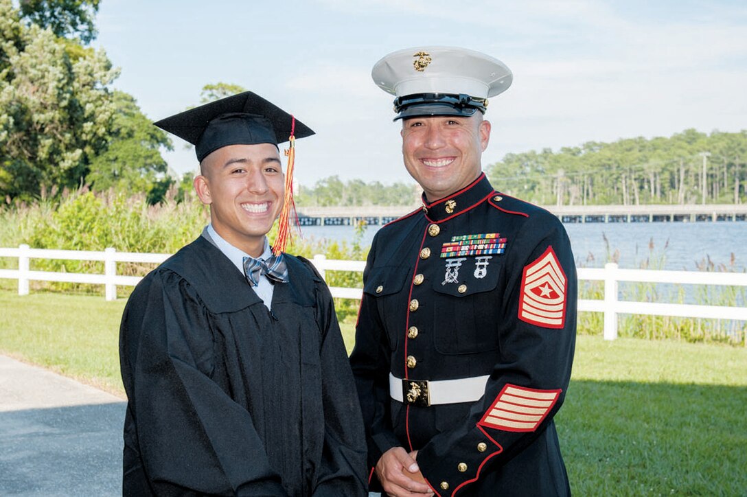 Marine Corps Scholarship Foundation scholarship recipient  Isaiah Leiva, stands beside his father, Sgt. Maj. Luis M. Leiva. Isaiah Leiva is a sophomore at the University of North Carolina.