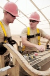 Senior Airman David Schrock ,left, and Tech. Sgt. Clayton Heimert review operating procedures for a four-wheel-drive service platform at Ali Base, Iraq May 14, 2010. Schrock is a heavy equipment operator deployed from Nellis AFB, Nev. Heimert is a civil engineer deployed from Camp Perry Air National Guard Base in Ohio.