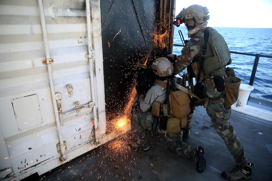 Critical Skills Operators with Bravo Company, 1st Marine Special Operations Battalion, U.S. Marine Corps Forces, Special Operations Command, saw through a steel door during Visit, Board, Search and Seizure training near Naval Base Coronado, Calif., Jan. 15. (Official Marine Corps photo by Sgt. Donovan Lee/released)