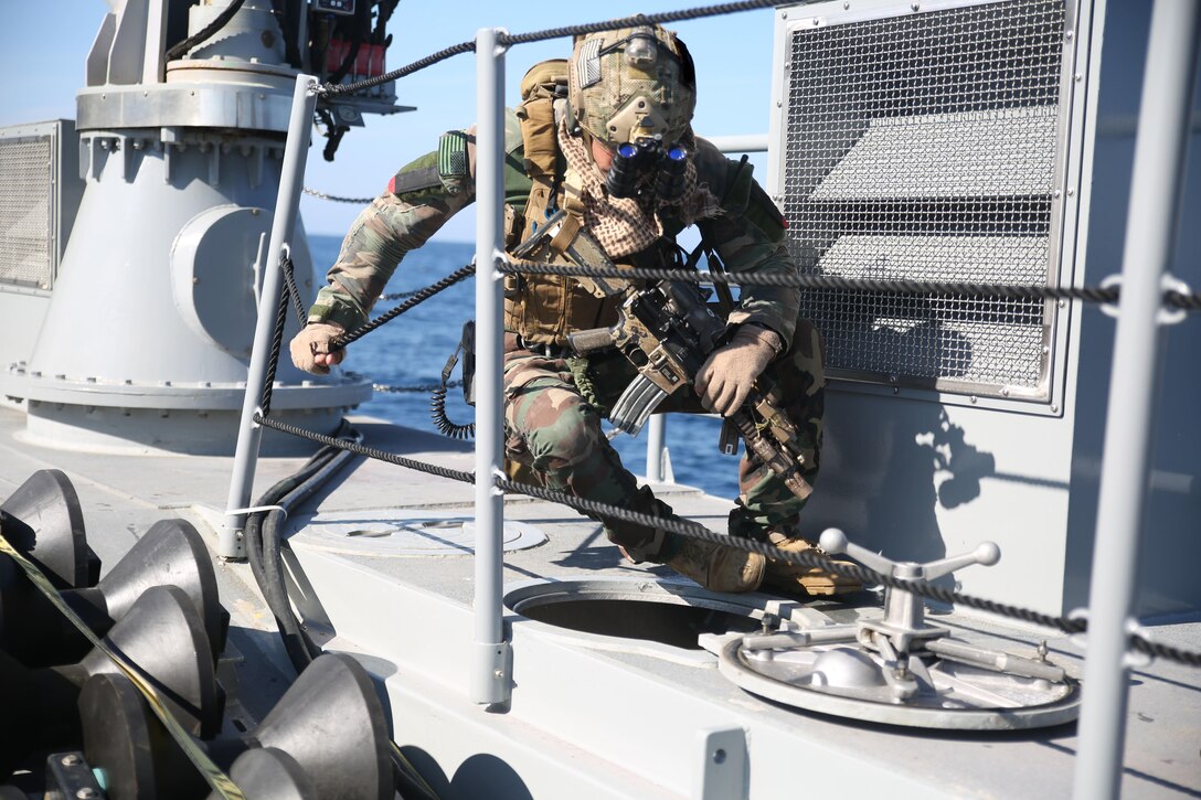 A Critical Skills Operator with Bravo Company, 1st Marine Special Operations Battalion, U.S. Marine Corps Forces Special Operations Command, goes through a hatch while searching a target vessel during Visit, Board, Search and Seizure training near Naval Base Coronado, Calif., Jan. 13. (Official Marine Corps photo by Sgt. Donovan Lee/released)