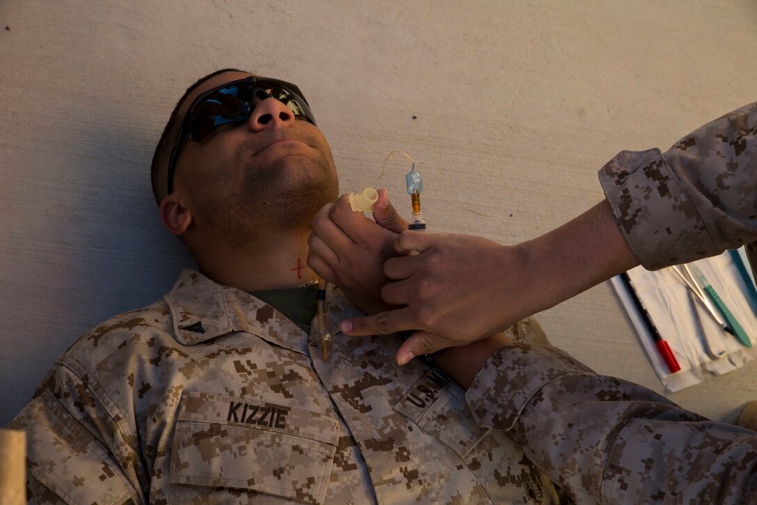 Lance Cpl. Michael K. Kizzie assists during a cricothyrotomy demonstration Jan. 21 in a combat care class during Integrated Training Exercise 15-2 at Marine Air Ground Combat Center, Twentynine Palms. A cricothyrotomy is a last resort method to create an airway on a patient. The combat care class is part of pre-training for ITX. Kizzie is a motor transport operator from Greensburg, Pennsylvania, currently assigned to 4th Marine Regiment, 3rd Marine Division, III Marine Expeditionary Force. 