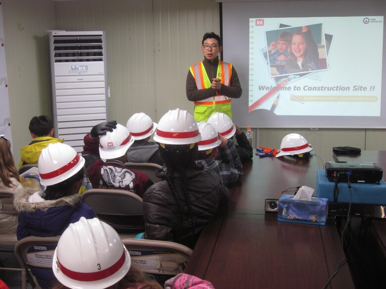 U.S. Army Corps of Engineers Central resident office project engineer James Lee provides students of Osan American Elementary School a brief video presentation and overview of the construction site of their future school.