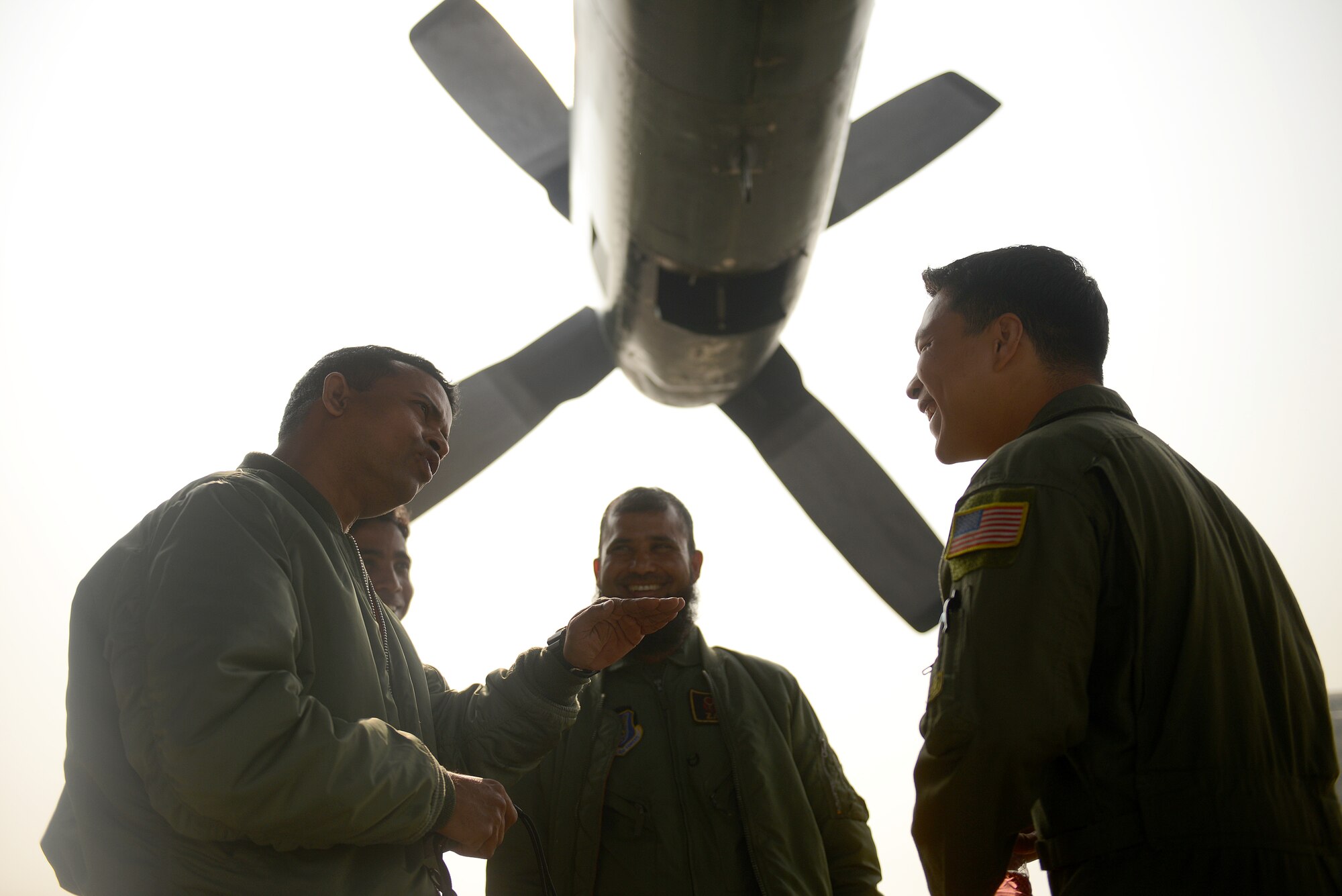U.S. Air Force Staff Sgt. Dan Muscutt, right, talks with a Bangladesh Air Force C-130B crew from the 101st Special Flying Unit during Exercise COPE SOUTH at BAF Base Bangabandhu, Jan. 27, 2015. Muscutt is a C-130H flight engineer assigned to the 36th Airlift Squadron, Yokota Air Base, Japan. COPE SOUTH helps cultivate common bonds, foster goodwill, and improve readiness and compatibility between members of the Bangladesh and U.S. Air Forces. (U.S. Air Force photo by 1st Lt. Jake Bailey/Released)