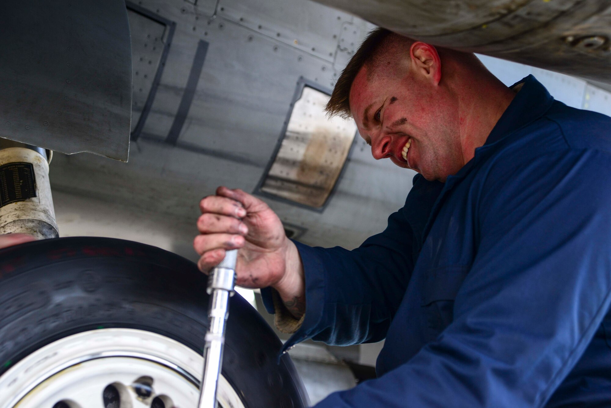 Staff Sgt. James McFadden, 35th Aircraft Maintenance Squadron dedicated crew chief, finishes off a tire change on an F-16 Fighting Falcon on Jan. 8, 2015, at Misawa Air Base, Japan. McFadden's duties as a crew chief are extensive, and include things like pre- and post-flight inspections, intake inspections and all-around maintenance. (U.S. Air Force photo by Staff Sgt. Derek VanHorn)