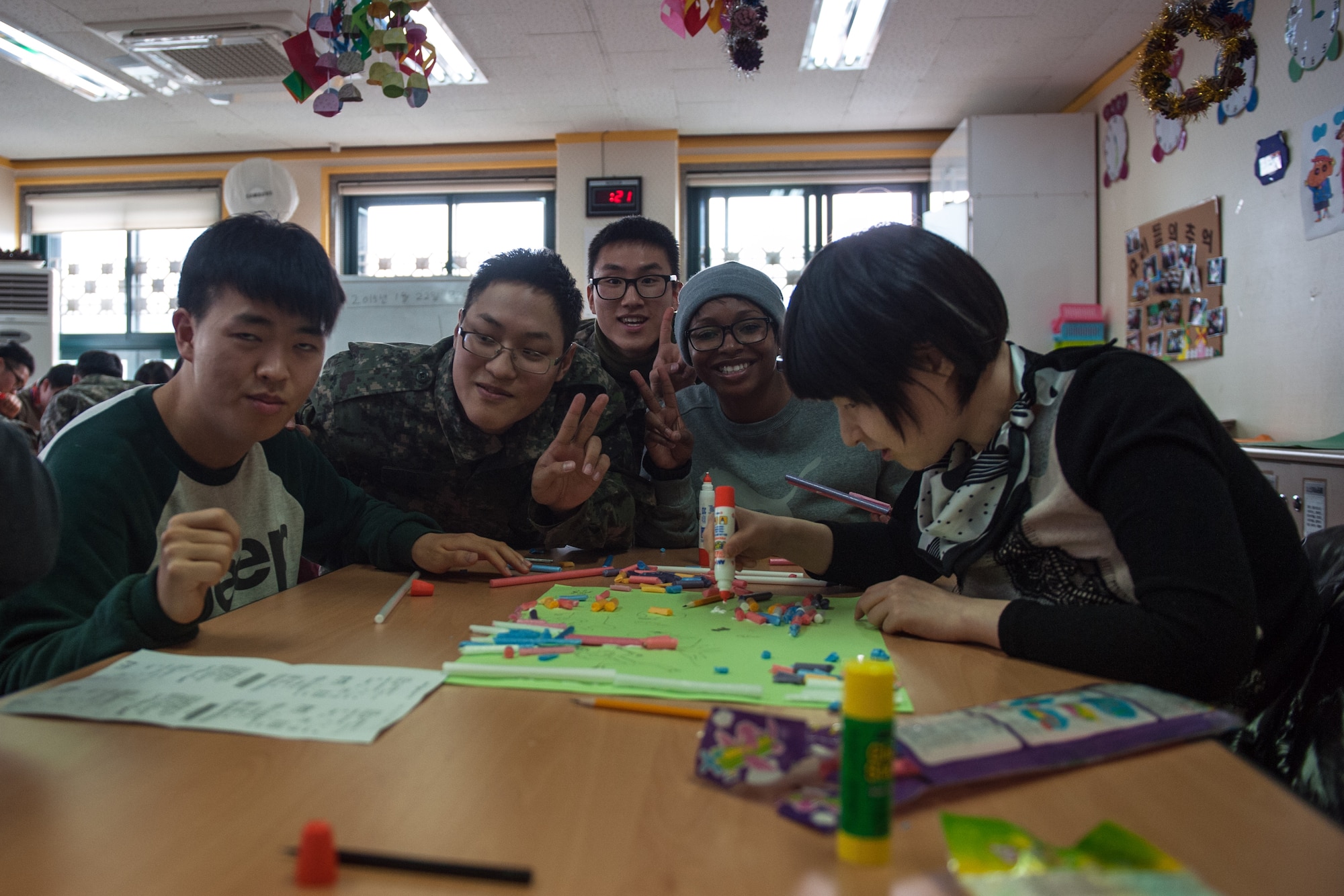 Members of both the Wolf Pack and Republic of Korea Air Force pose for a photo with residents of the Gunsan City Rehabilitation Center during a volunteer event in Gunsan City, ROK, Jan. 22, 2015. ROKAF and U.S. Air Force members volunteered for the day at the rehabilitation center as part of a monthly community service project. (U.S. Air Force photo by Senior Airman Taylor Curry/Released) 