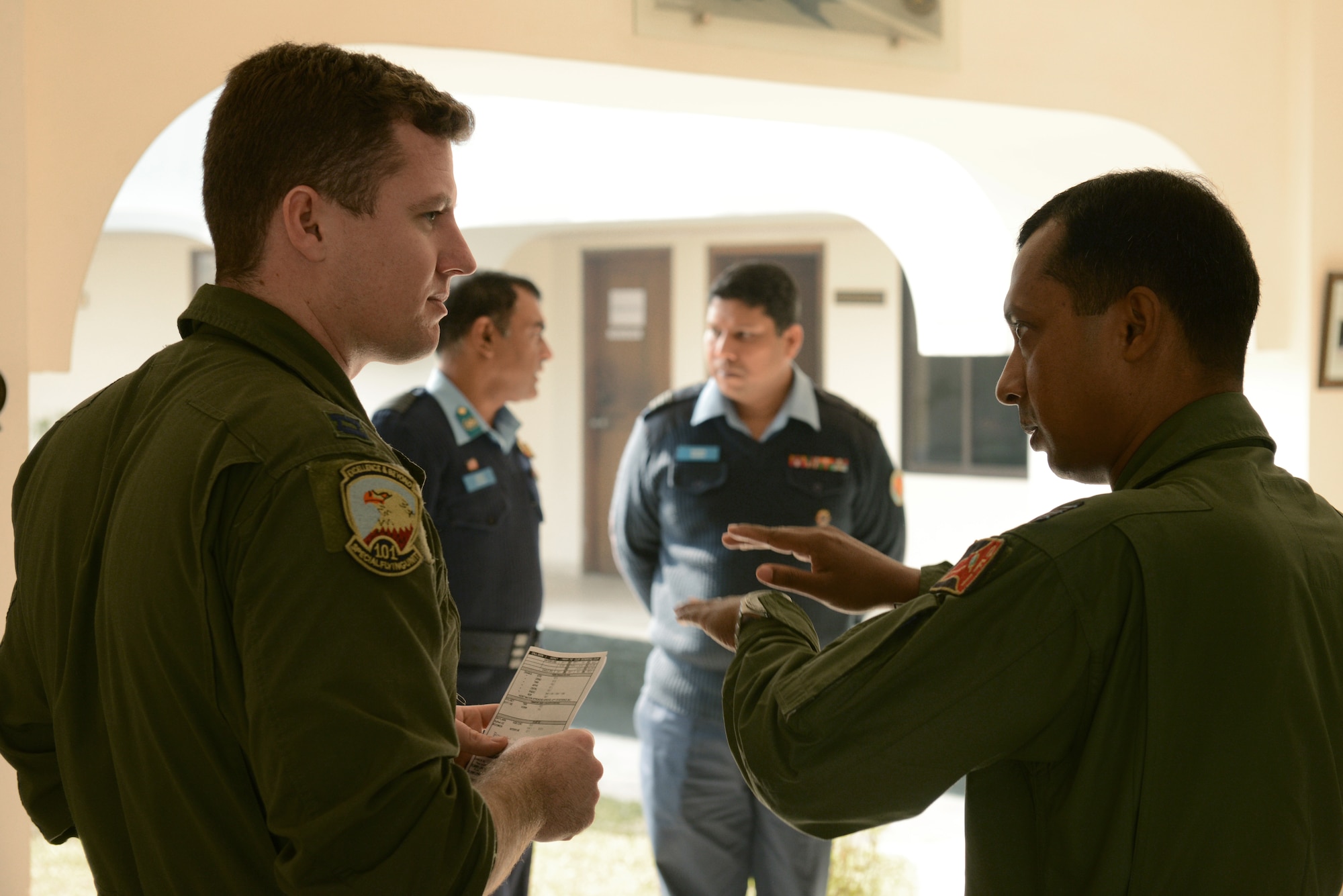 U.S. Air Force Capt. Evan Dineen, a C-130H aircraft pilot assigned to the 36th Airlift Squadron, Yokota Air Base, Japan, discusses mission planning with a Bangladesh Air Force counterpart during Exercise COPE SOUTH at BAF Base Bangabandhu,  Bangladesh, Jan. 28, 2015. COPE SOUTH is a Pacific Air Forces-sponsored, bilateral tactical airlift exercise conducted in Bangladesh, with a focus on cooperative flight operations, day and night low-level navigation, tactical airdrop, and air-land missions as well as subject-matter expert exchanges in the fields of operations, maintenance and rigging disciplines. (U.S. Air Force photo by 1st Lt. Jake Bailey/Released)