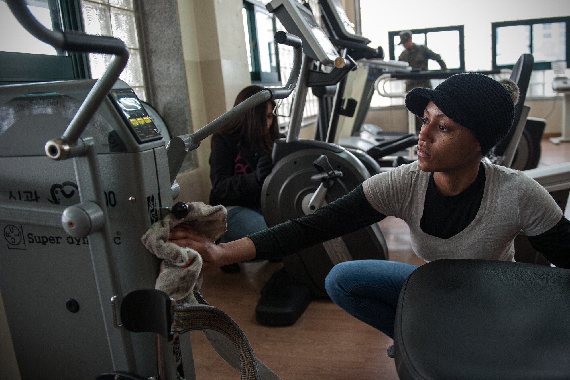 Staff Sgt. Erica Austin, 8th Medical Group unit deployment manager, cleans exercise equipment at the Gunsan City Rehabilitation Center during a volunteer event in Gunsan City, Republic of Korea, Jan. 22, 2015. U.S. Air Force and ROK Air Force members volunteered for the day at the rehabilitation center to help clean the facility and interact with the residents. (U.S. Air Force photo by Senior Airman Taylor Curry/Released) 