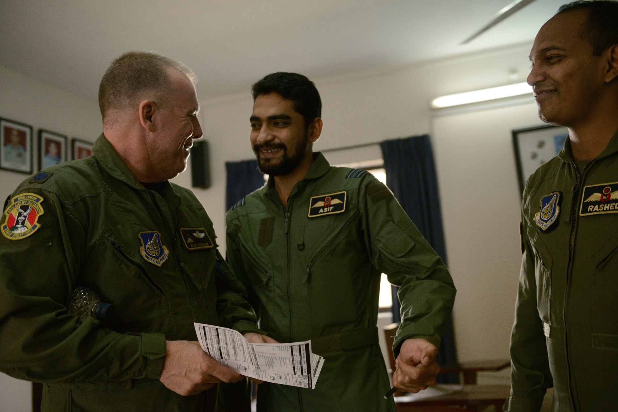 U.S. Air Force Lt. Col. Rick Richard, an evaluator pilot assigned to the 36th Airlift Squadron, Yokota Air Base, Japan, discusses mission planning with Bangladesh Air Force Squadron Leader Asif during Exercise COPE SOUTH at BAF Base Bangabandhu,  Bangladesh, Jan. 28, 2015. COPE SOUTH is a Pacific Air Forces-sponsored, bilateral tactical airlift exercise conducted in Bangladesh, with a focus on cooperative flight operations, day and night low-level navigation, tactical airdrop, and air-land missions as well as subject-matter expert exchanges in the fields of operations, maintenance and rigging disciplines. (U.S. Air Force photo by 1st Lt. Jake Bailey/Released)