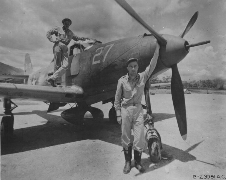 On February 6, 1943, 2d Lt Edwin A. Schneider scored three aerial victories, contributing to the 40th Fighter Squadron and 35th Fighter Group's record for the highest number of aerial victories scored in a single day.  Pictured here, Schneider stands by his P-39 Airacobra.  (U.S. Air Force historical photo/Released)