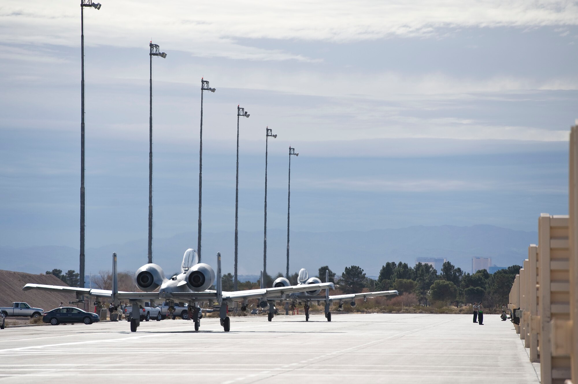 Two A-10 Thunderbolt IIs assigned to the 355th Operations Group, Davis-Monthan Air Force Base, Ariz., taxi out to the flightline during Green Flag-West 15-03 at Nellis Air Force Base, Nev., Jan. 26, 2015. Students in the A-10C initial qualification program had a unique opportunity to train outside of their home-station environment, better preparing them for their first operational squadron. (U.S. Air Force photo by Airman 1st Class Mikaley Towle)