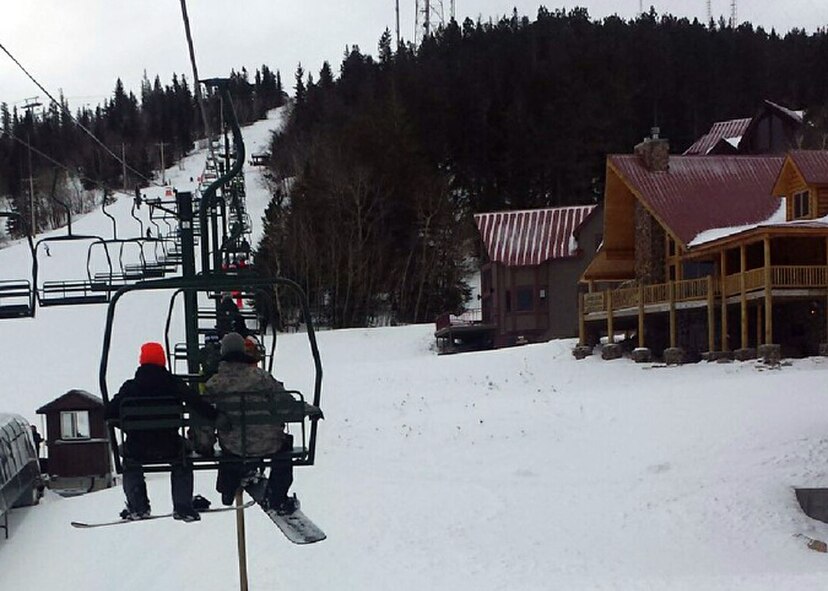 Airmen ride a ski lift during a Single Airman Initiative ski and snowboarding trip at Terry Peak, S.D., Jan. 25, 2015. The SAI, which is organized by the 28th Force Support Squadron, allows single Airmen, enlisted and officer, to take advantage of a variety of recreational and indoor activities free of charge, such as Canvas and Pottery 2 Paint, a cooking class and Dorm Night Cosmic Bowling at the Bandit Lanes. (U.S. Air Force courtesy photo/Released) 