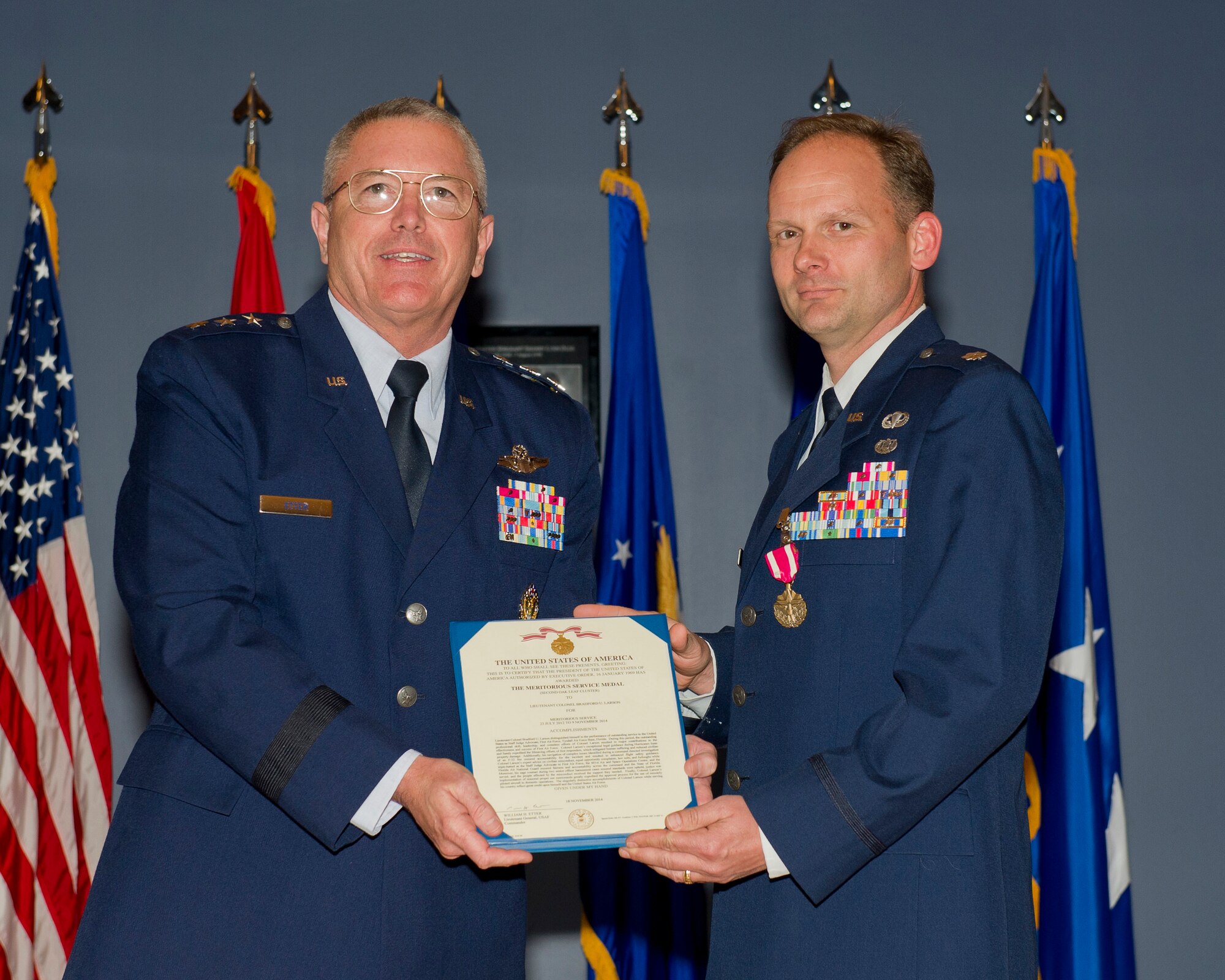 At the Jan. 22 Commanders Call at the Horizons Community Center, Lt. Gen. William Etter, Commander, Continental U.S. North American Aerospace Defense Command Region - 1st Air Force (Air Forces Northern), presents Lt. Col. Bradford Larson, Staff Judge Advocate, 601st Air Operations Center, the Meritorious Service Medal, Second Oak Leaf Cluster, July 23 2012 to Nov. 9 2014. (U.S. Air Force Photo by Master Sgt. Kurt Skoglund/Released)

