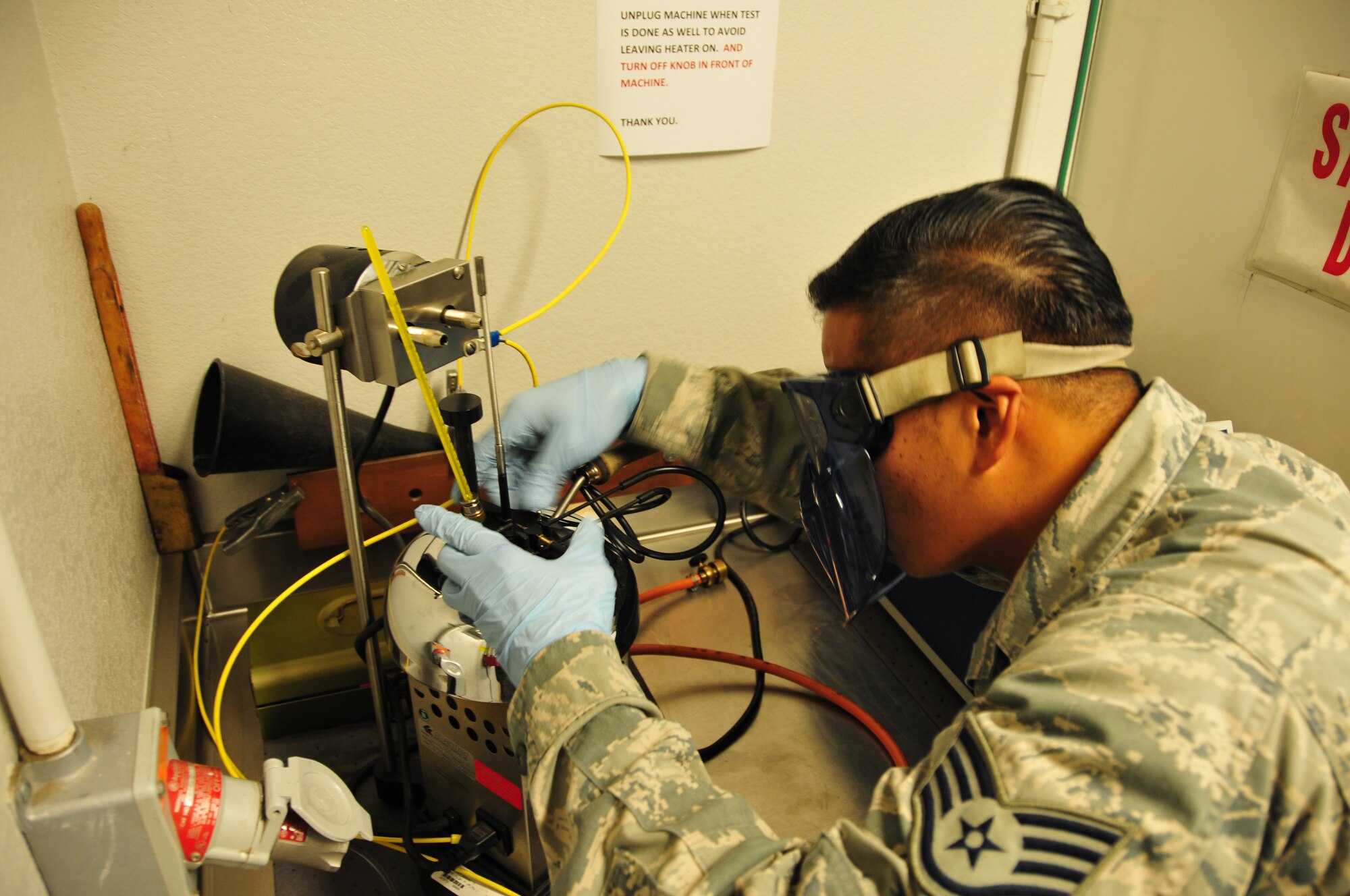 Staff Sgt. Benedict Barroga, 161st Logistics Readiness Squadron fuels technician, analyses fuel as part of a fuel quality control test, 161st Air Refueling Wing, Phoenix, Jan. 29, 2015. This test ensures fuel additives are present and in the specified quantities. The fuel is tested when the base initially received it, as well as twice a month, to ensure that the fuel received here meets the highest standards required by the U.S. Air Force. (U.S. Air National Guard photo by Tech. Sgt. Michael Matkin/Released)