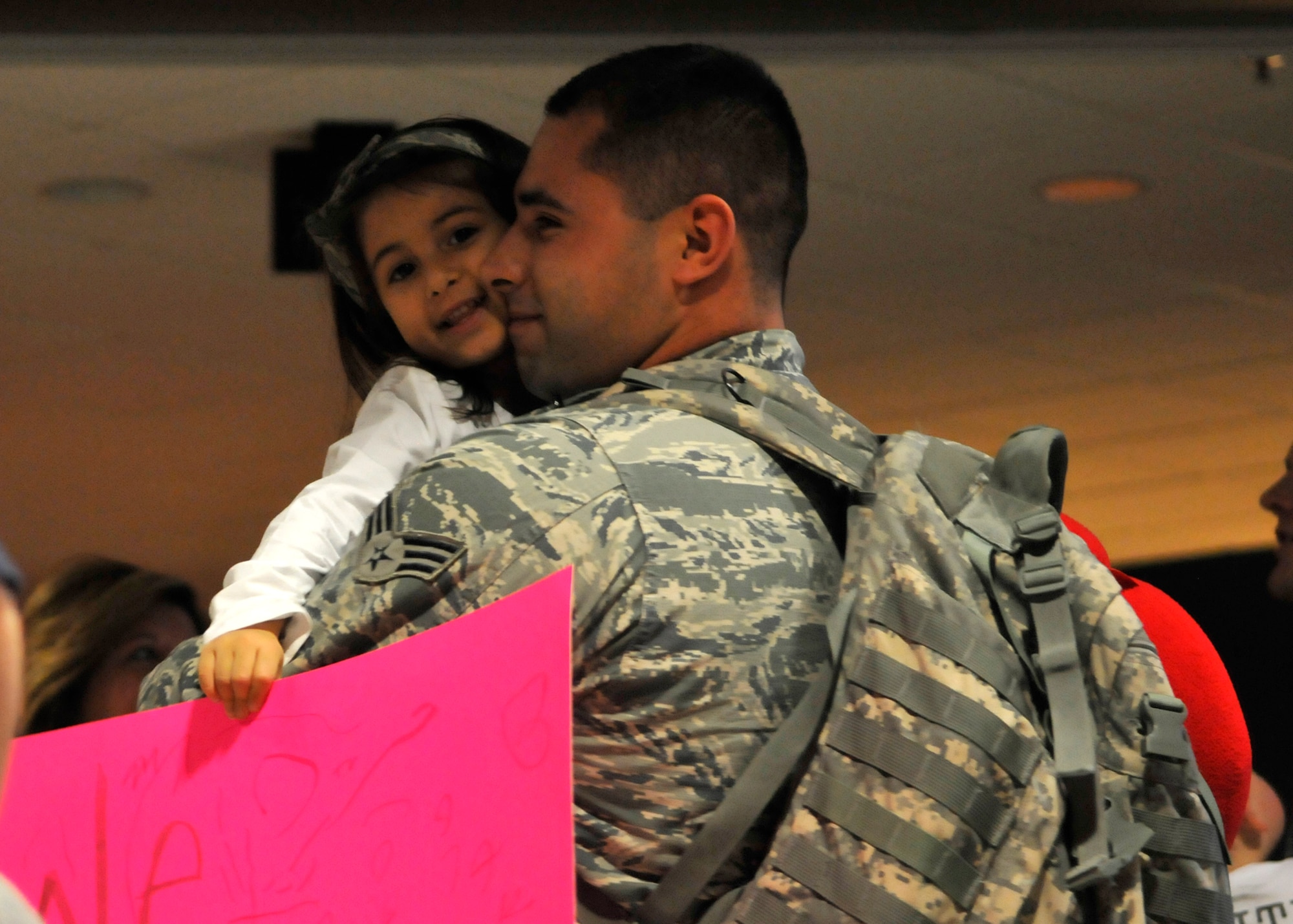 FORT WAYNE AIR NATIONAL GUARD BASE, Ind. – Senior Airman Mario Boone, 122nd Fighter Wing, Security Forces, embraces his daughter as the 122nd Fighter Wing welcomed home more than two-dozen members from the 122nd Security Forces Squadron, as they returned from a six-month deployment in support of Operation Enduring Freedom, January 23, 2015 at the Fort Wayne International Airport.  Twenty-six Blacksnakes mobilized for this deployment and were assigned to the 379th Expeditionary Security Forces Squadron at Al Udeid Air Base, Qatar. The group spent one month in San Antonio conducting combat preparation, then transitioned to Qatar for six months. 