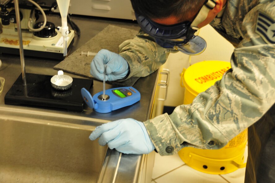 Staff Sgt. Benedict Barroga, 161st Logistics Readiness Squadron fuels technician, conducts a fuel flash point test, 161st Air Refueling Wing, Phoenix, Jan. 29, 2015. This test finds the lowest temperature at which fuel from a fuel sample will 'flash' when an ignition source is applied. A change in flash point may indicate the presence of potentially dangerous contaminants, such as excess water. If there is too much water, the fuel can freeze and the water crystals can cause engines to shut down, said Master Sgt. Romano Cedillos, 161 LRS fuels technician. The fuel is tested when the base initially received it, as well as twice a month, to ensure that the fuel received here meets the highest standards required by the U.S. Air Force. (U.S. Air National Guard photo by Tech. Sgt. Michael Matkin/Released)