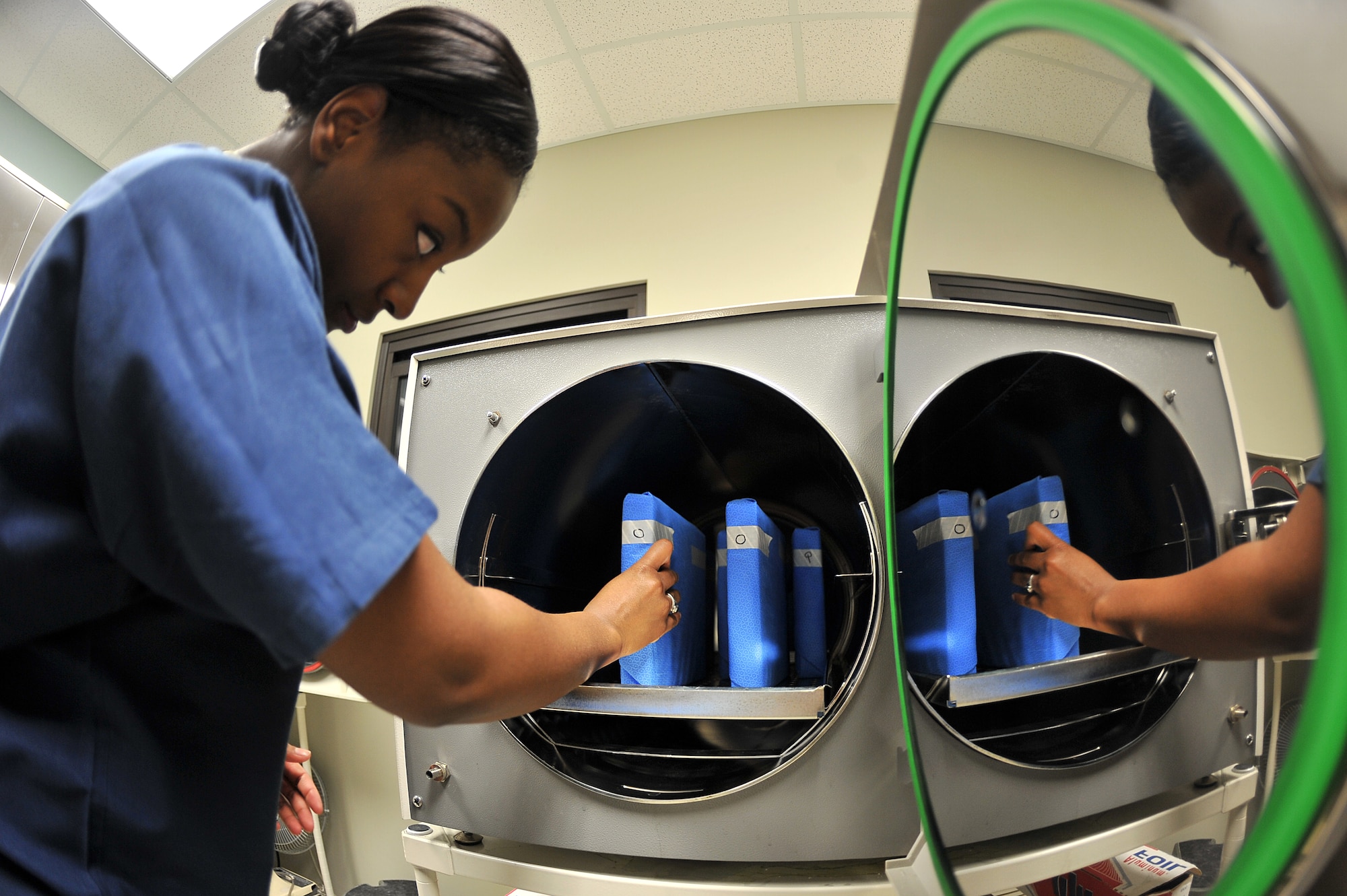 ALTUS AIR FORCE BASE, Okla. – U.S. Air Force Airman 1st Class Vinecia Anderson, 97th Medical Group prophylaxis assistant, places a wrapped dental instrument kit into a sterilization unit during routine equipment cleaning inside the Dental Clinic Jan. 28, 2015. The sterilization unit ensures that each dental instrument kit is 100% sterilized before it can be used again. (U.S. Air Force photo by Senior Airman Dillon Davis/Released)