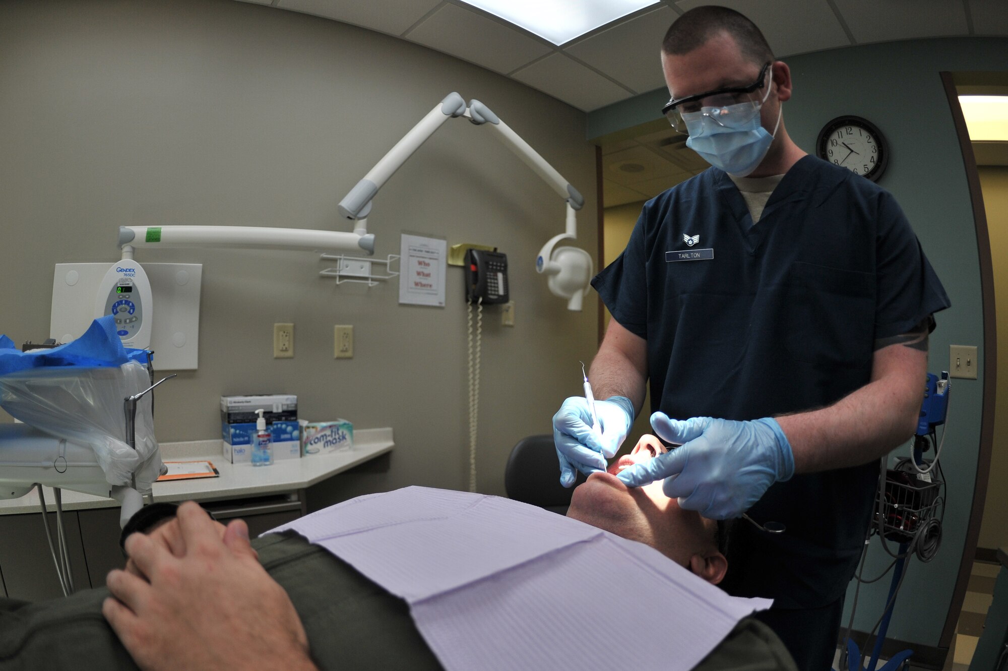 ALTUS AIR FORCE BASE, Okla. – U.S. Air Force Senior Airman Caleb Tarlton, 97th Medical Group prophylaxis assistant, cleans the teeth of U.S. Air Force Lt. Col. Anthony Thomas, 58th Airlift Squadron director of staff, during a routine cleaning appointment inside the Dental Clinic Jan. 28, 2015. The Altus AFB Dental Clinic performs annual cleaning and checkups for all Airmen stationed or temporarily assigned to the base to ensure medical readiness and mission capability. (U.S. Air Force photo by Senior Airman Dillon Davis/Released)