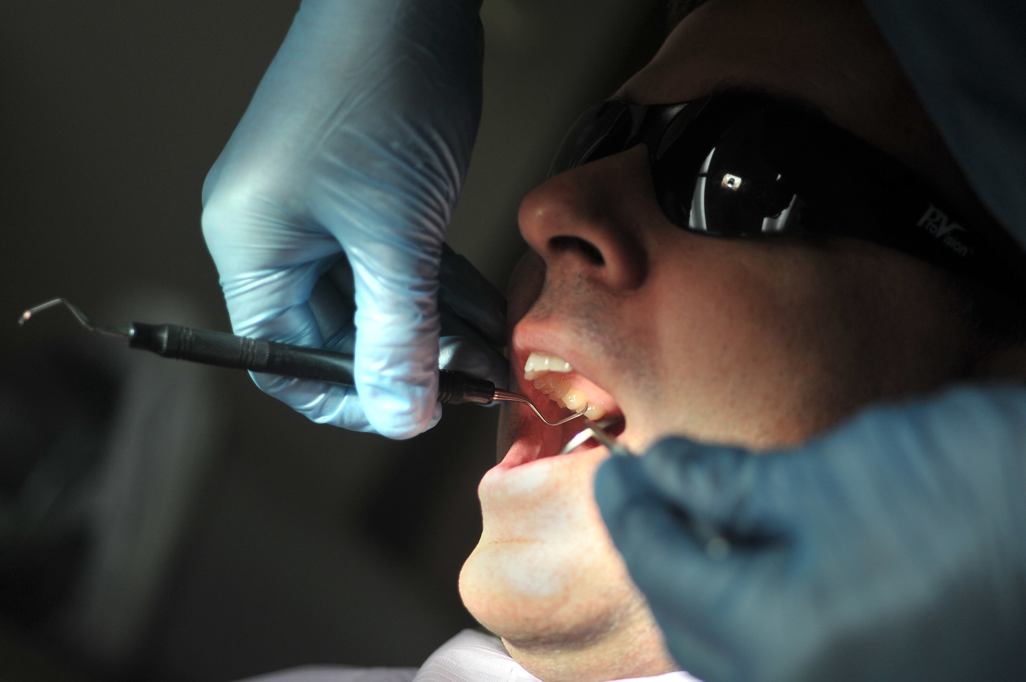 ALTUS AIR FORCE BASE, Okla. – U.S. Air Force Senior Airman Caleb Tarlton, 97th Medical Group prophylaxis assistant, cleans the teeth of U.S. Air Force Lt. Col. Anthony Thomas, 58th Airlift Squadron director of staff, during a routine cleaning appointment inside the Dental Clinic Jan. 28, 2015. The Dental Clinic at Altus AFB provides world-class support for all of the Airmen stationed and temporarily assigned to the base. (U.S. Air Force photo by Senior Airman Dillon Davis/Released)