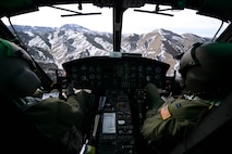 1st Lt. Greg Johnston, left, and Capt. RJ Bergman, both 40th Helicopter Squadron rescue pilots, fly their UH-1N Huey over a mountain range Jan. 27, 2015, near Malmstrom Air Force Base, Mont. The flight took the crew over a variety of terrain and altitudes, from flatlands to valleys and mountains. (U.S. Air Force photo/ Airman 1st Class Dillon Johnston)