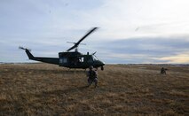 Senior Airman William Lamb, left, and Airman 1st Class Jordan Gilliand, both 341st Security Forces Group Tactical Response Force members, provide security as a UH-1N Huey lands for extraction. Lamb and Gilliand trained on infiltration and exfiltration from a helicopter during a routine launch facility security sweep. (U.S. Air Force photo/ Airman 1st Class Dillon Johnston)