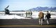 Aircrew and security forces members walk back to a UH-1N Huey Jan. 27, 2015, at the Lewistown Municipal Airport in Lewistown, Mont. The crew stopped to get fuel and lunch during a launch facility security mission. (U.S. Air Force photo/ Airman 1st Class Dillon Johnston)