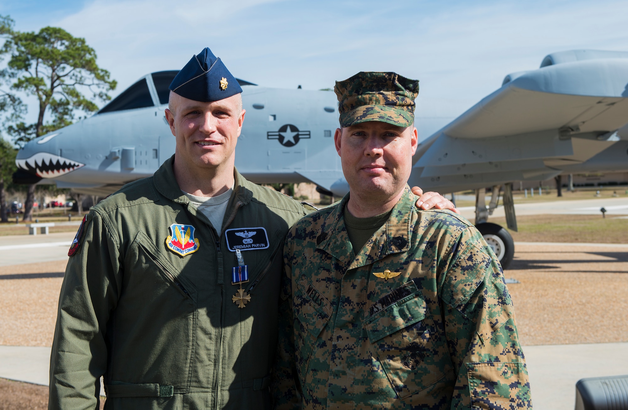 U.S. Air Force Maj. Jeremiah ‘Bull’ Parvin, 75th Fighter Squadron director of operations, and U.S. Marine Corps Master Gunnery Sgt. Richard Wells, senior enlisted advisor of Marine Special Operations School, pose for a photo Jan. 29, 2015, at Moody Air Force Base, Ga. Parvin received the Distinguished Flying Cross with Valor for his heroic actions that saved the lives of Wells’ team during a 2008 deployment to Afghanistan. (U.S. Air Force photo by Airman 1st Class Ceaira Tinsley/Released)