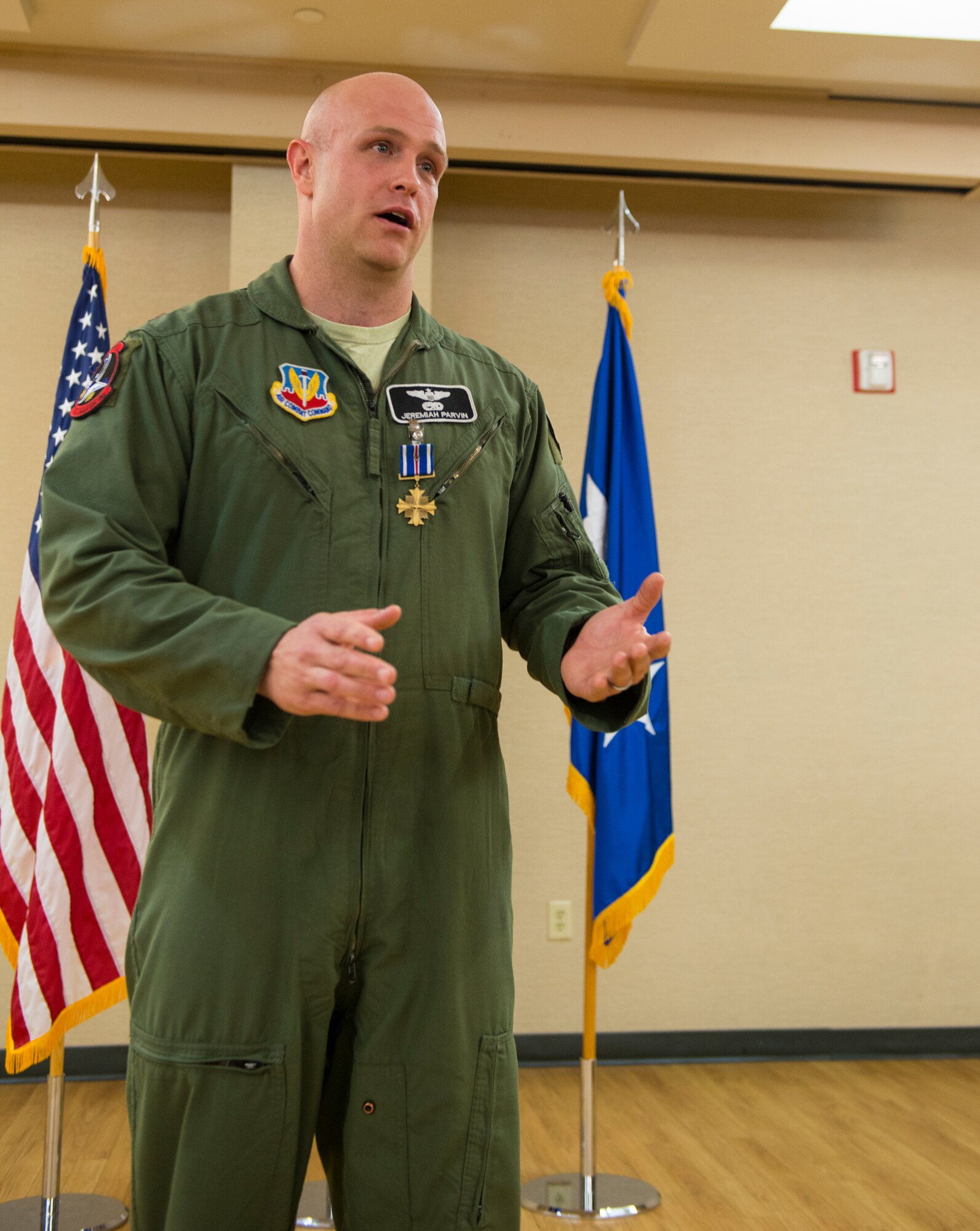 U.S. Air Force Maj. Jeremiah ‘Bull’ Parvin, 75th Fighter Squadron director of operations, gives a speech during his Distinguished Flying Cross with Valor Ceremony Jan. 29, 2015, at Moody Air Force Base, Ga. Maj. Gen. H. D. Polumbo Jr., Ninth Air Force commander, presided over the ceremony and presented Parvin with the DFC medal. (U.S. Air Force photo by Airman 1st Class Ceaira Tinsley/Released)