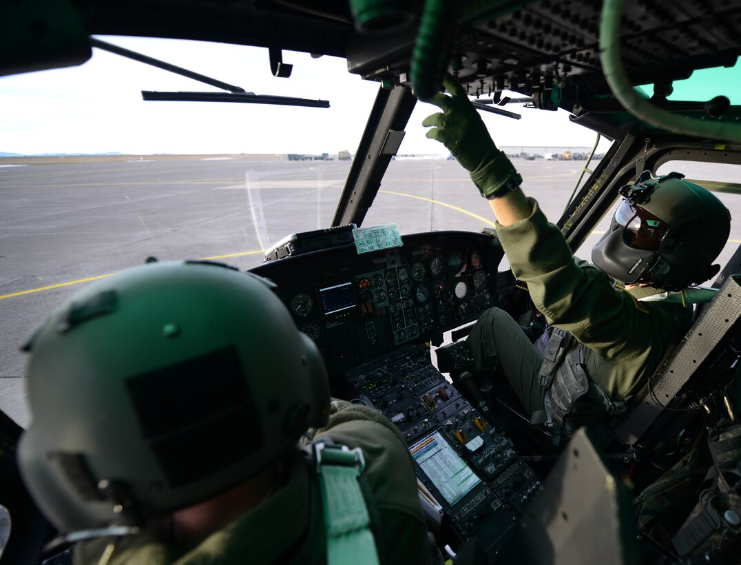 Capt. RJ Bergman, right, and 1st Lt. Greg Johnston, both 40th Helicopter Squadron rescue pilots, perform startup procedures in a UH-1N Huey Jan. 27, 2015, at Malmstrom Air Force Base, Mont. Both pilots work together to safely operate the aircraft while providing navigational and terrain awareness for each other. (U.S. Air Force photo/ Airman 1st Class Dillon Johnston)