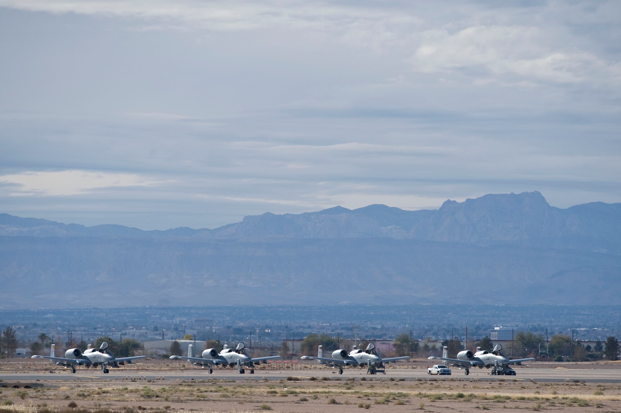 A flight of four A-10 Thunderbolt IIs assigned to the 355th Operations Group, Davis-Monthan Air Force Base, Ariz., line up on the flightline during Green Flag-West 15-03 at Nellis Air Force Base, Nev., Jan. 26, 2015. Green Flag-West 15-03 is a joint close air support exercise with the U.S. Army taking place in the National Training Center at Fort Irwin, Calif. (U.S. Air Force photo by Airman 1st Class Mikaley Towle)