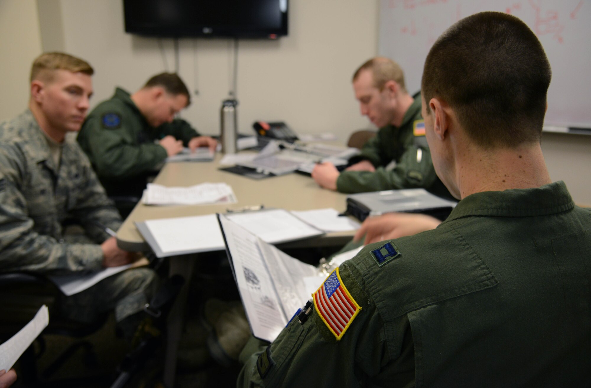 Capt. RJ Bergman, right, 40th Helicopter Squadron rescue pilot, speaks to his crew as part of a pre-flight briefing Jan. 27, 2015, at Malmstrom Air Force Base, Mont. Bergman went over flight plans, safety and evacuation procedures and time and fuel constraints. (U.S. Air Force photo/ Airman 1st Class Dillon Johnston)