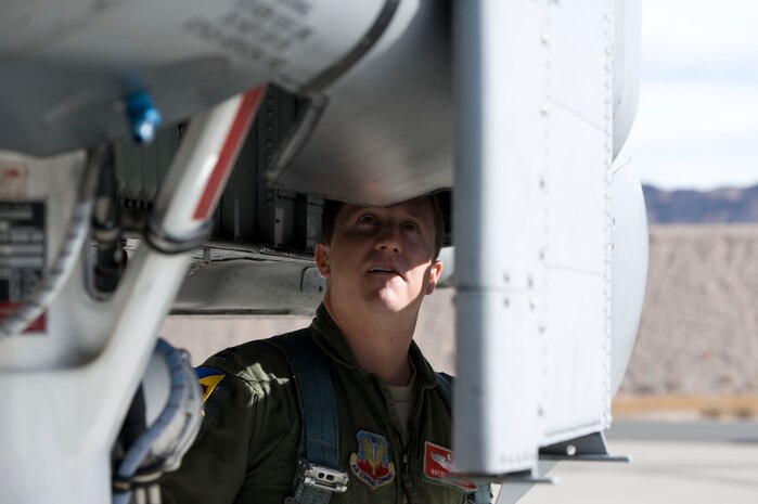 Capt. Brent Fleming, an A-10 Thunderbolt II instructor pilot assigned to the 355th Operations Group, Davis-Monthan Air Force Base, Ariz., preforms pre-flight inspections during Green Flag-West 15-03 at Nellis Air Force Base, Nev., Jan. 26, 2015. The 355th Operations Group consists of five squadrons and more than 300 personnel employing 83 A-10C aircraft and an AN/TPS-75 radar system. (U.S. Air Force photo by Airman 1st Class Mikaley Towle)