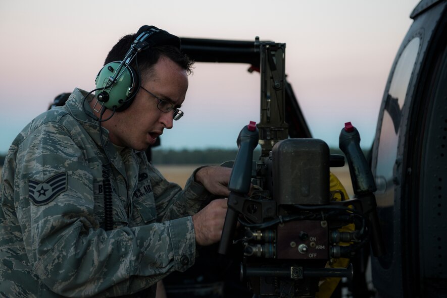 U.S. Air Force Staff Sgt. Michael Bellantoni, 41st Helicopter Maintenance Unit weapons load crew chief, detaches a machine gun from an HH-60G Pave Hawk during a short-notice deployment exercise Jan. 28, 2015, at Moody Air Force Base, Ga. The 723d Aircraft Maintenance Squadron participated in the exercise to test the 23d Wing’s deployment readiness. (U.S. Air Force photo by Airman 1st Class Dillian Bamman/Released)