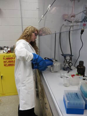 Stephanie Long, a Cedarville University student researcher assigned to the Air Force Research Laboratory's Materials and Manufacturing Directorate under the guidance of Dr. Joy Haley, safely transfers liquid nitrogen from one container to another. (U.S. Air Force photo/Robyn Mack)