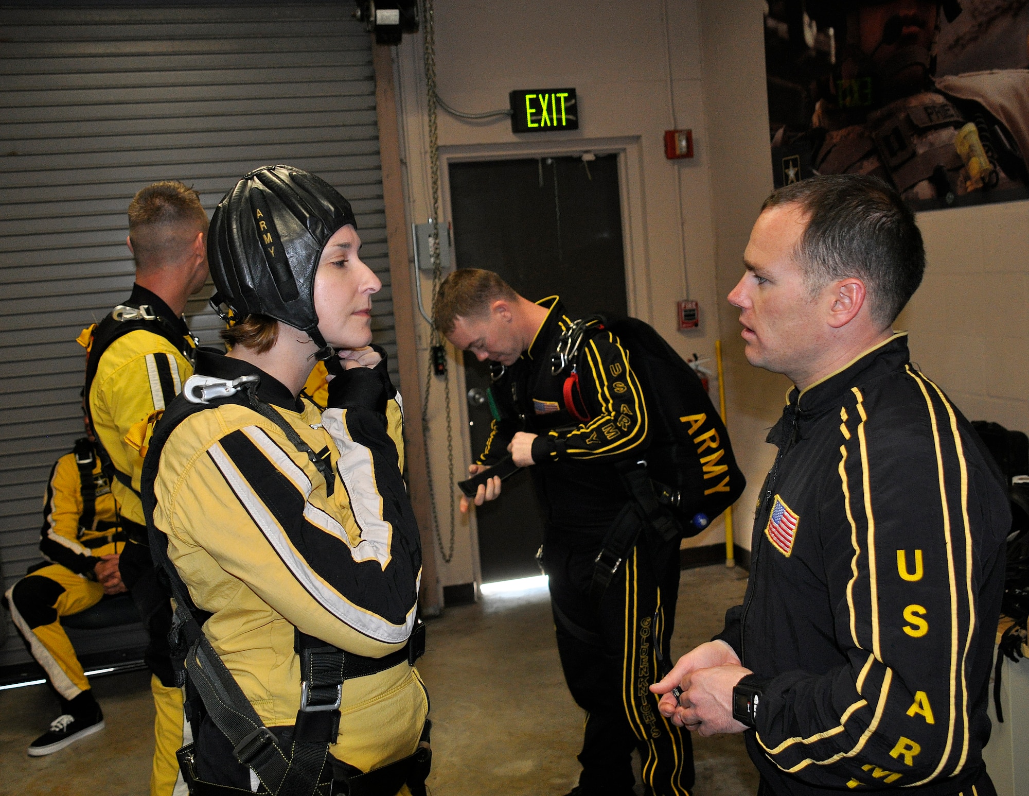 Sgt. 1st Class Jon Ewald, tandem instructor with the U.S. Army Parachute Team: The Golden Knights, gives some pre-jump instruction to Maj. Brooke Cortez, 482nd Fighter Wing Public Affairs chief, prior to a tandem jump at Homestead Air Reserve Base, Fla., on Jan. 29.  The Golden Knights are conducting their sixth straight year of winter training at Homestead ARB. (U.S. Air Force photo/Tim Norton)