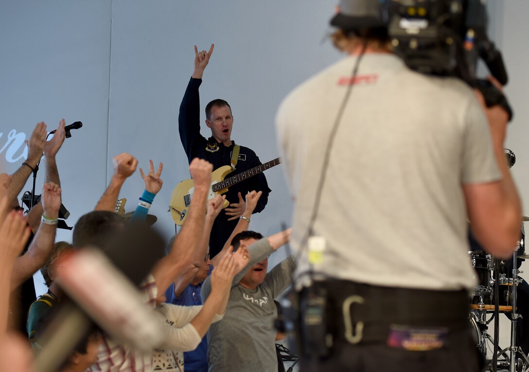 Master Sgt. Matthew Geist, the U.S. Air Force Band Max Impact guitarist, shouts during a recording for Entertainment Sports and Programming Network at Fan Fest in Scottsdale, Az., Jan. 28, 2015. The band performed a 45-second rendition of the ESPN Sport Center’s theme song.  (U.S. Air Force photo/ Senior Airman Nesha Humes)