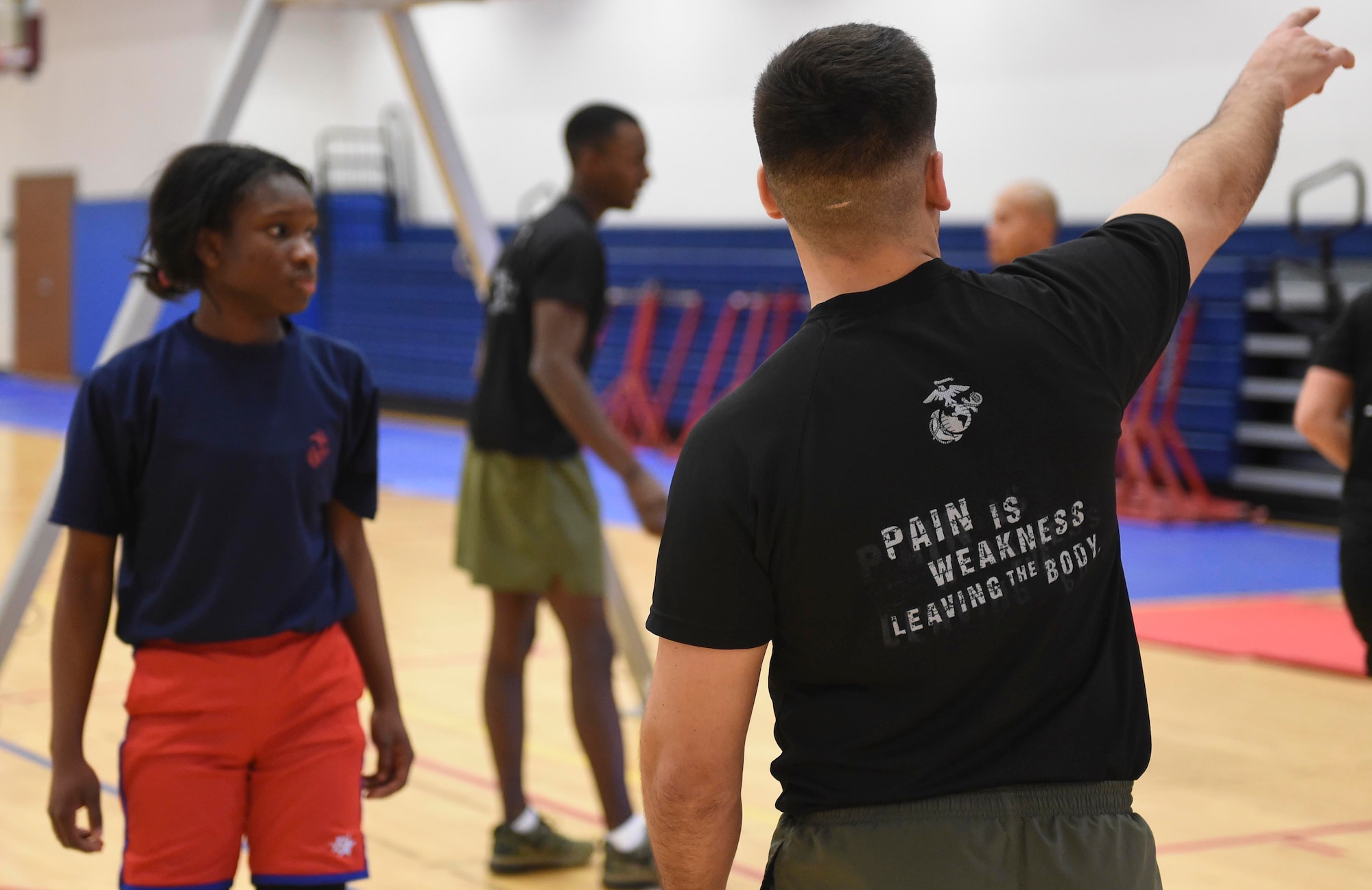A recruiter gives instructions to a poolee during a delayed entry program all-female workout held Jan. 17, 2015, at the fitness center on Buckley Air Force Base, Colo. Poolees are members of the DEP that have not yet shipped out to recruit training. The DEP workouts are strenuous to enable poolees to be accustomed to the tough workouts and mental stress they will endure during recruit training. (U.S. Air Force photo by Airman 1st Class Samantha Saulsbury/Released)