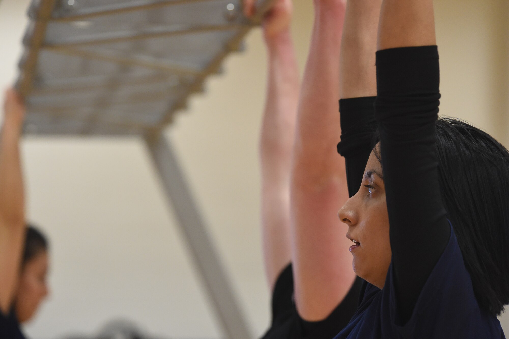 A U.S. Marine Corps poolee rests between pull-ups during a delayed entry program all-female workout held Jan. 17, 2015, at the fitness center on Buckley Air Force Base, Colo. Poolees are members of the DEP that have not yet shipped out to recruit training. The DEP workouts consist of strengthening exercises to enable the poolees to be accustomed to the strenuous workouts and stress they will endure once they arrive at recruit training. (U.S. Air Force photo by Airman 1st Class Samantha Saulsbury/Released)