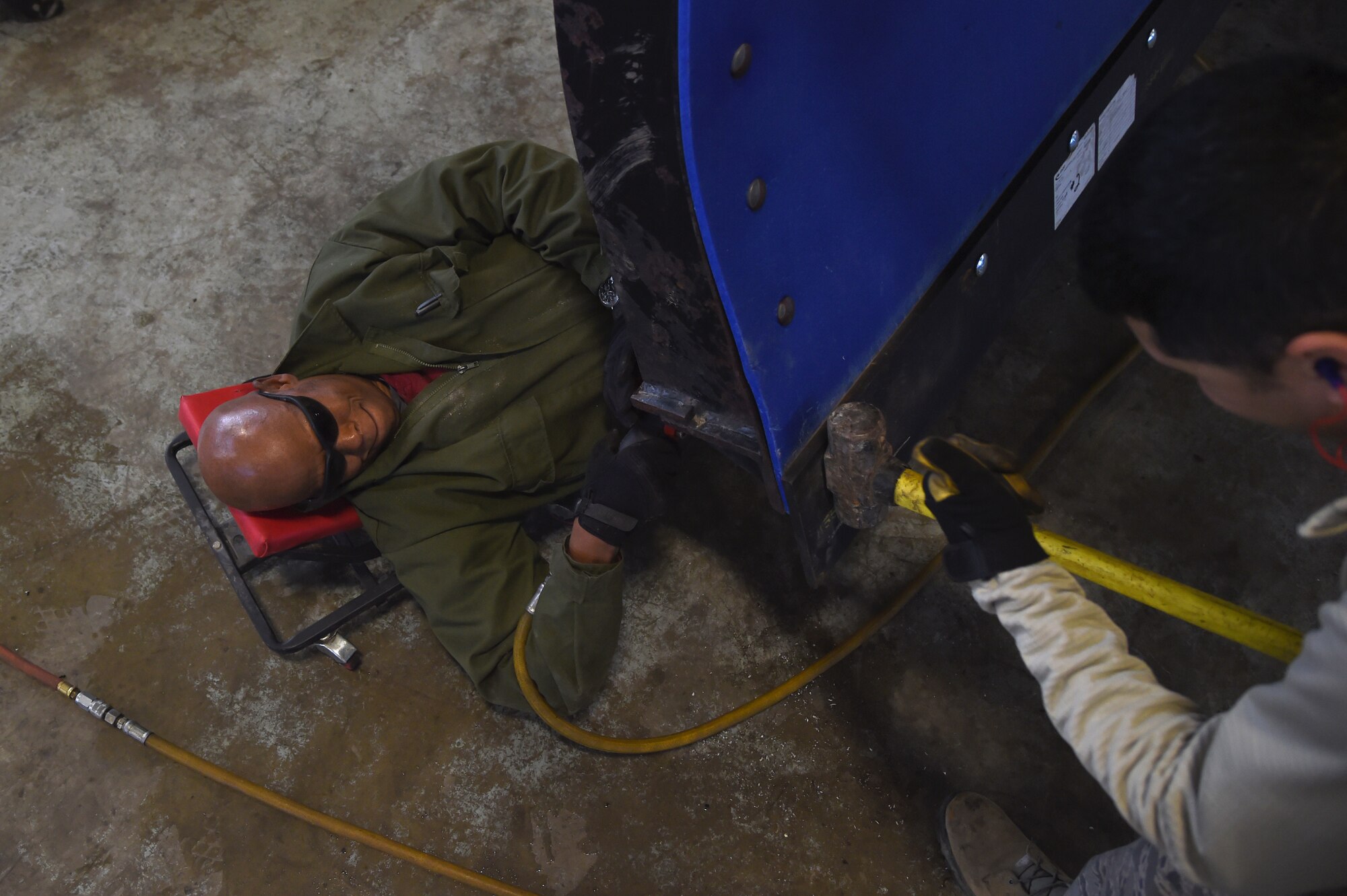 Edward Bell, 11th Civil Engineer Squadron heavy equipment operator, and SSgt Gilbert Feliciano, 113th Wing National Guard heavy equipment operator, replace a snow plow blade in the snow barn on Joint Base Andrews, Jan. 28, 2015. Snow plow blades are regularly replaced after extended periods of use. (U.S. Air Force photo/ Airman 1st Class J.D. Maidens)