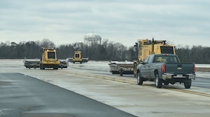 A snow removal team from the 11th Civil Engineer Squadron patrols for ice buildup on the Joint Base Andrews flight line, Jan 26, 2015. After snow and ice have been removed, heavy equipment patrols the flight line for newly-formed ice. (U.S. Air Force photo/ Airman 1st Class J.D. Maidens)