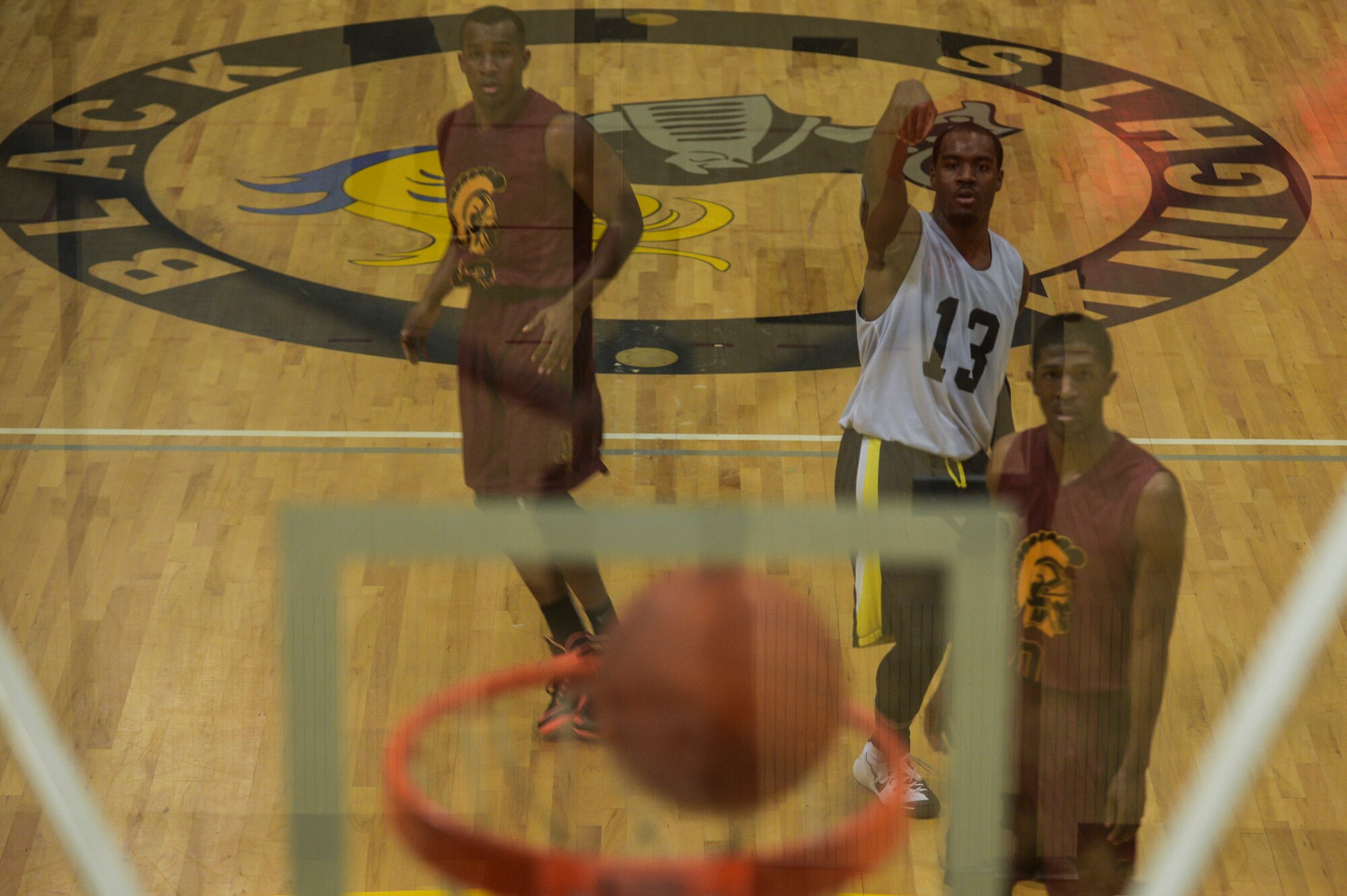 Members of the 19th Medical Group intramural basketball team watch as a shot bounces around the rim Jan. 26, 2014, at Little Rock Air Force Base, Ark. The final score was 63-52, 19th MDG. (U.S. Air Force photo/Senior Airman Cliffton Dolezal)