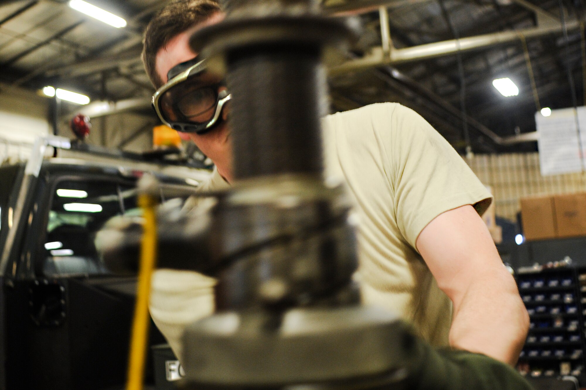 Senior Airman William Hankins, a 19th Maintenance Squadron aerospace ground equipment journeyman, uses a hammer to peen the threads on a fuselage jack Jan. 9, 2015, at Little Rock Air Force Base, Ark. A fuselage jack is used to elevate an aircraft to allow for easier maintenance. (U.S. Air Force photo by Senior Airman Cliffton Dolezal)