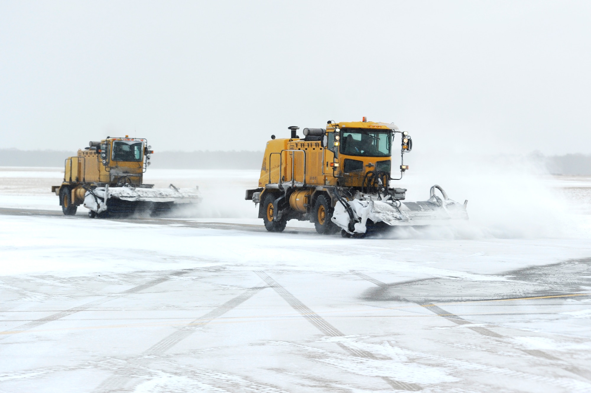 An 87th Civil Engineer Squadron member operates a snow plow to clear a taxiway Jan. 27, 2015, at Joint Base McGuire-Dix-Lakehurst, N.J. The 87th CES members worked around the clock to clear the aftermath of Wnter Storm Juno, returning the base to normal operations. (U.S. Air Force photo by Airman 1st Class Sean M. Crowe/Released)